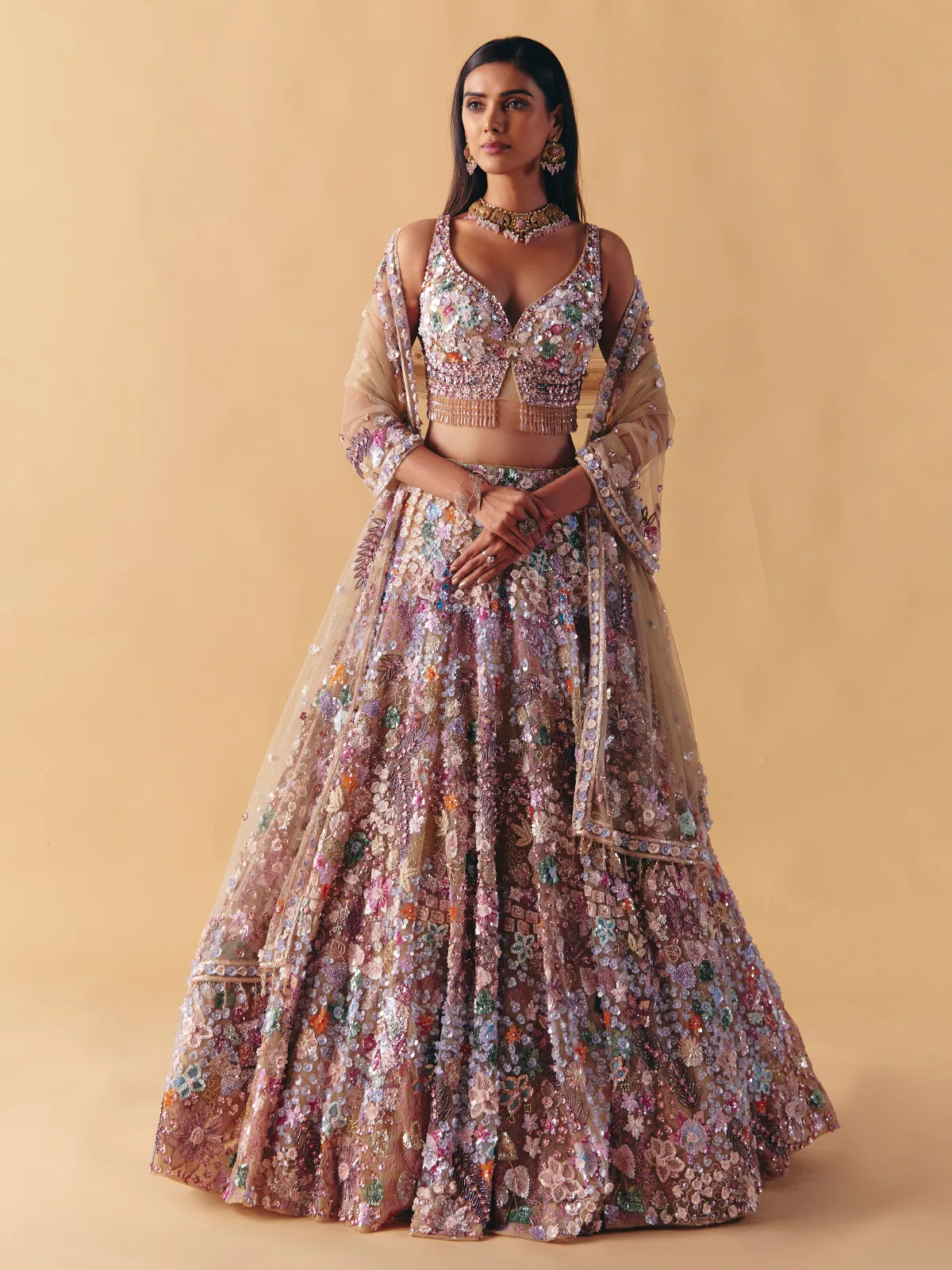 Beige net lehenga choli with beaded and pearl accents