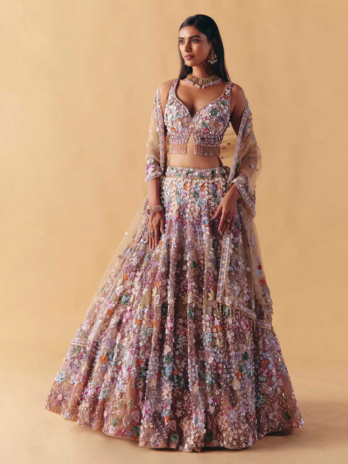 Beige net lehenga choli with beaded and pearl accents