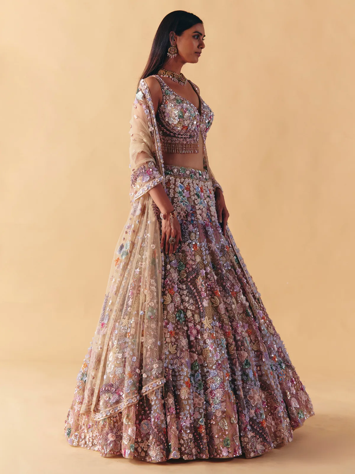 Beige net lehenga choli with beaded and pearl accents