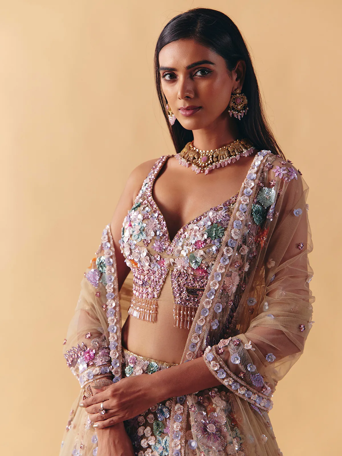 Beige net lehenga choli with beaded and pearl accents