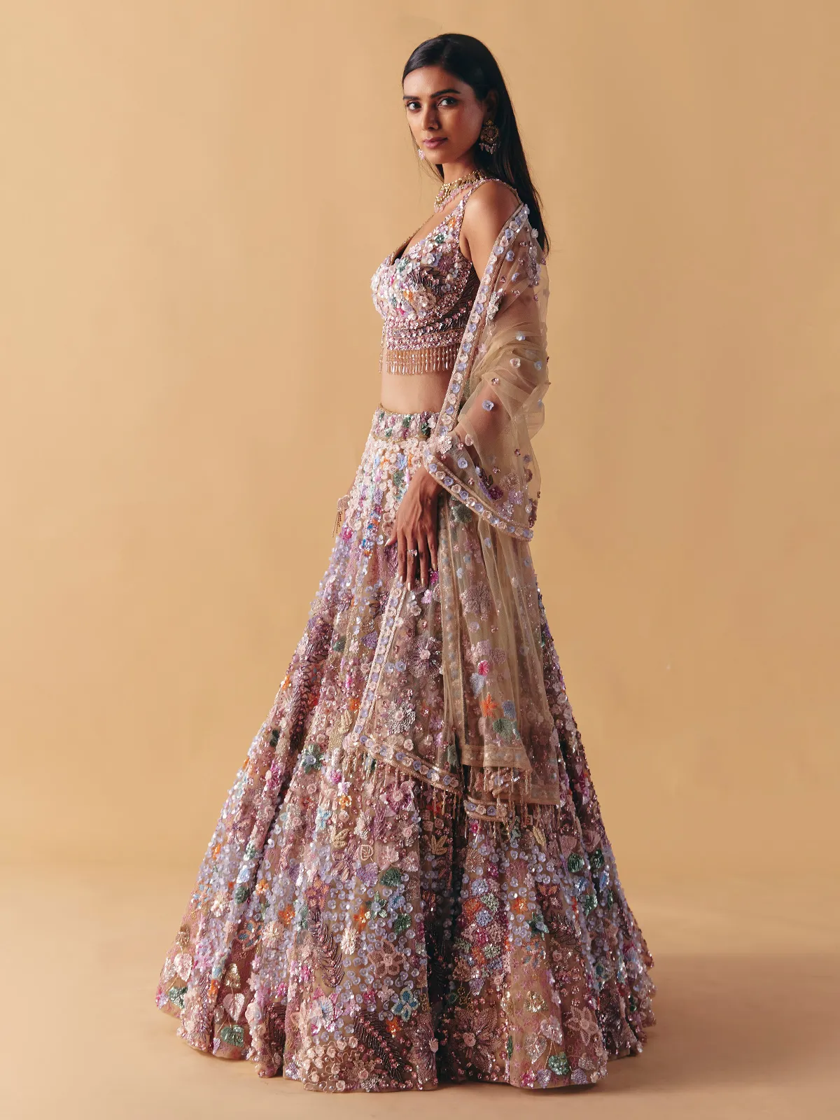 Beige net lehenga choli with beaded and pearl accents