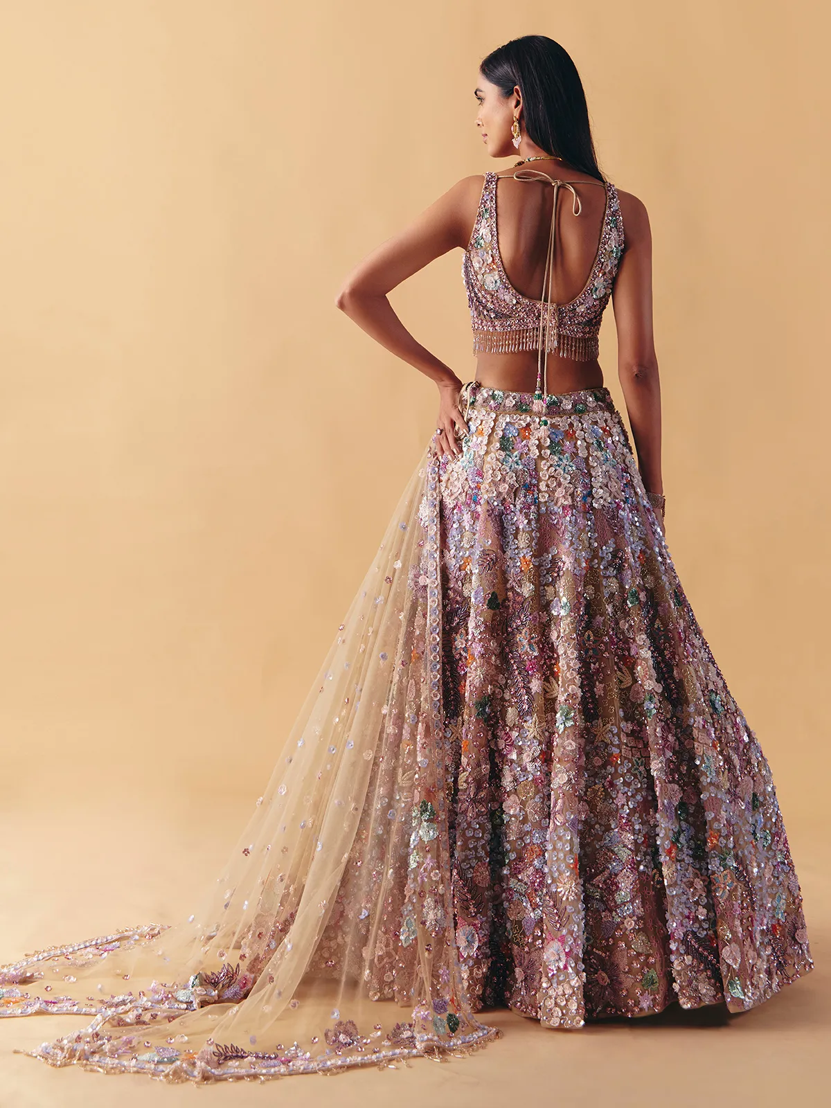 Beige net lehenga choli with beaded and pearl accents