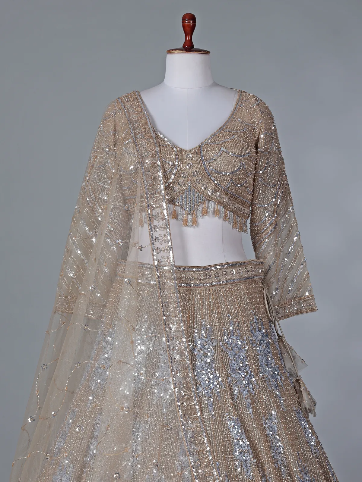 Beige net reception wear lehenga choli with rich sequins work