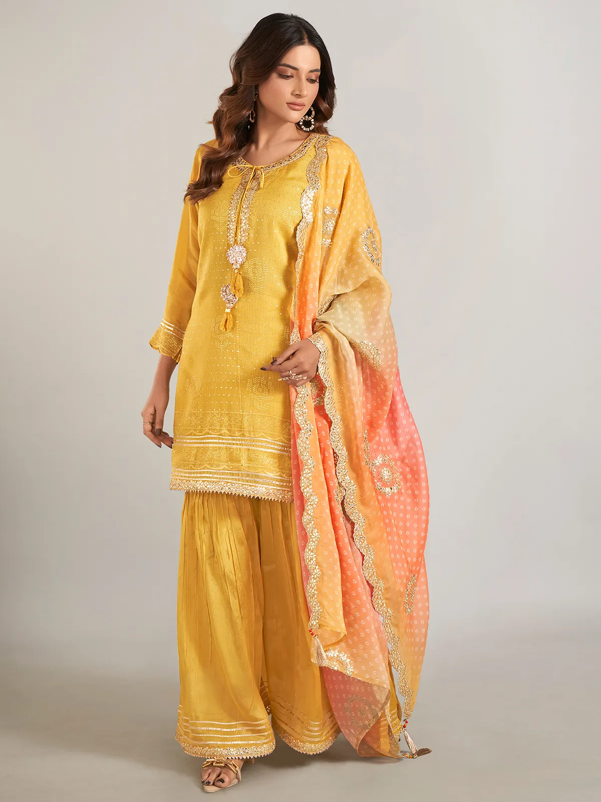 Mustard yellow silk sharara suit with dupatta