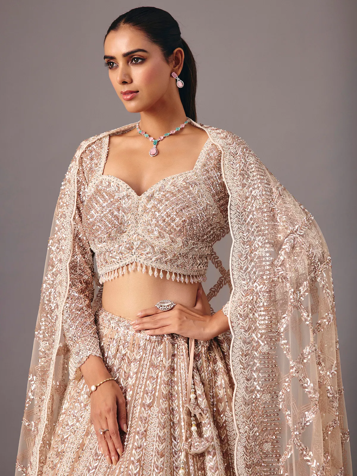 Beige net lehenga choli with pearl and sequin detailing