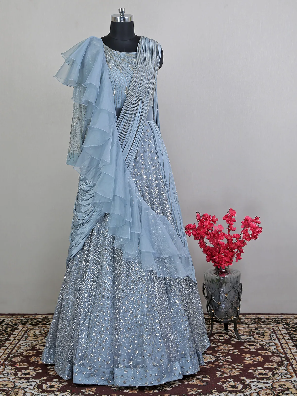 Blue net floor length gown with draped odhani pattern