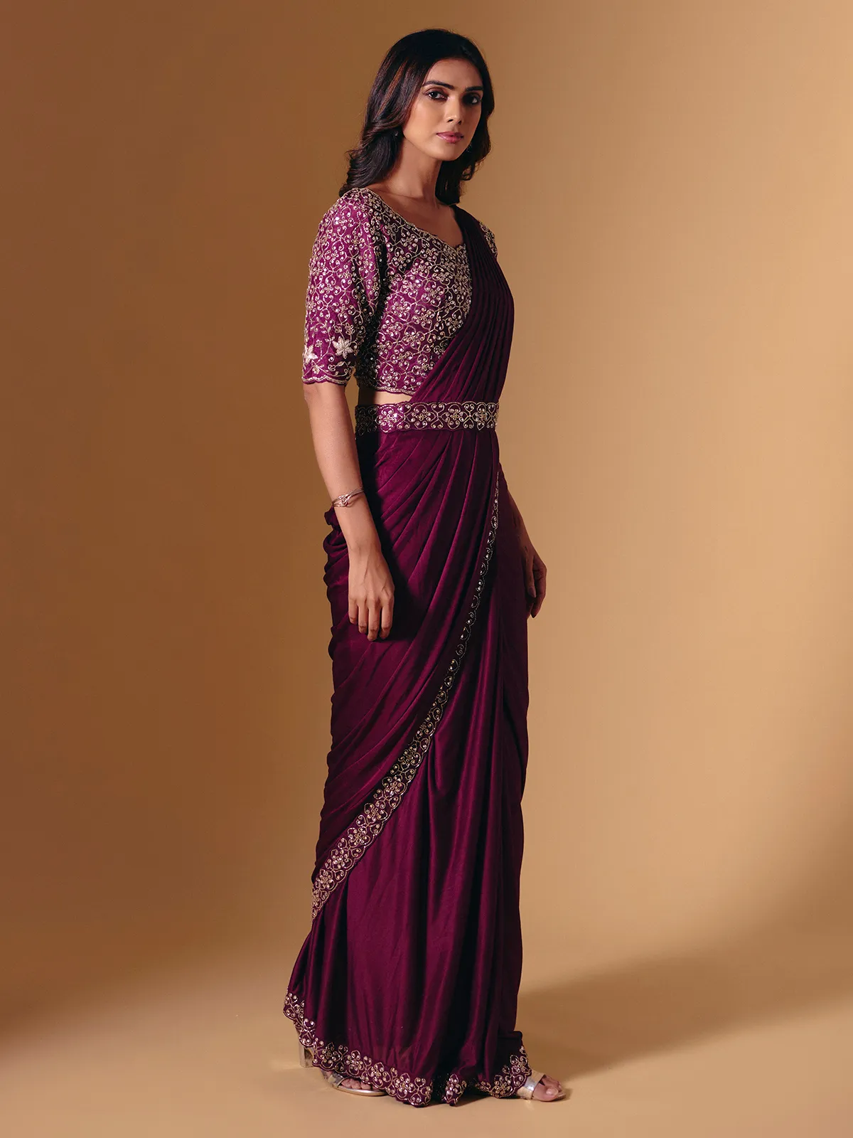Dark purple lycra saree with shimmering cutdana design