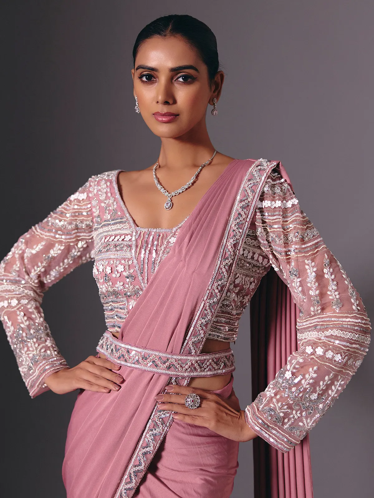 Onion pink lycra saree with heavy festive embellishments