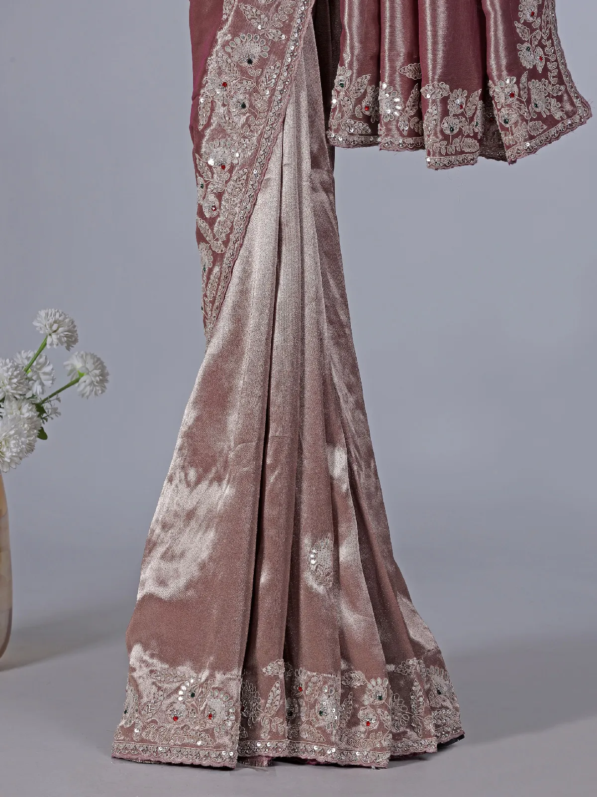 Pastel peach soft tissue silk saree with exquisite embellished work