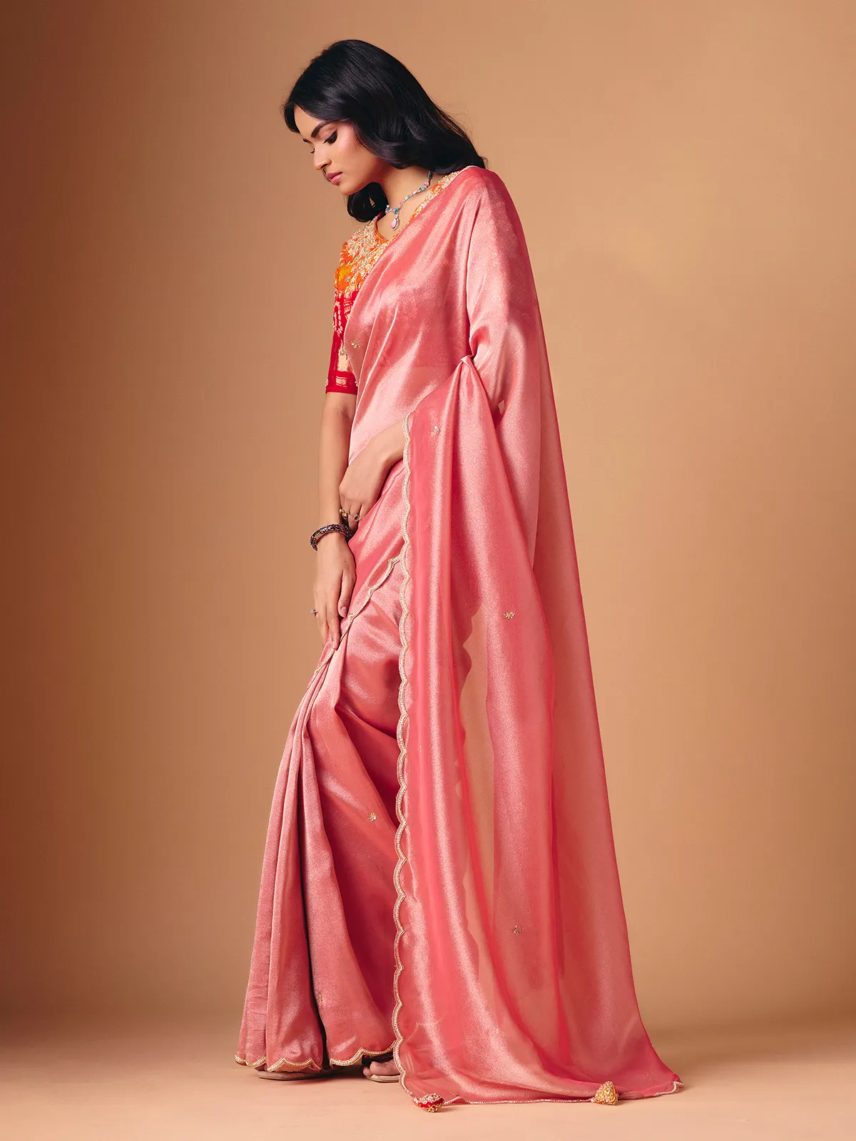 Peach tissue silk embellished saree