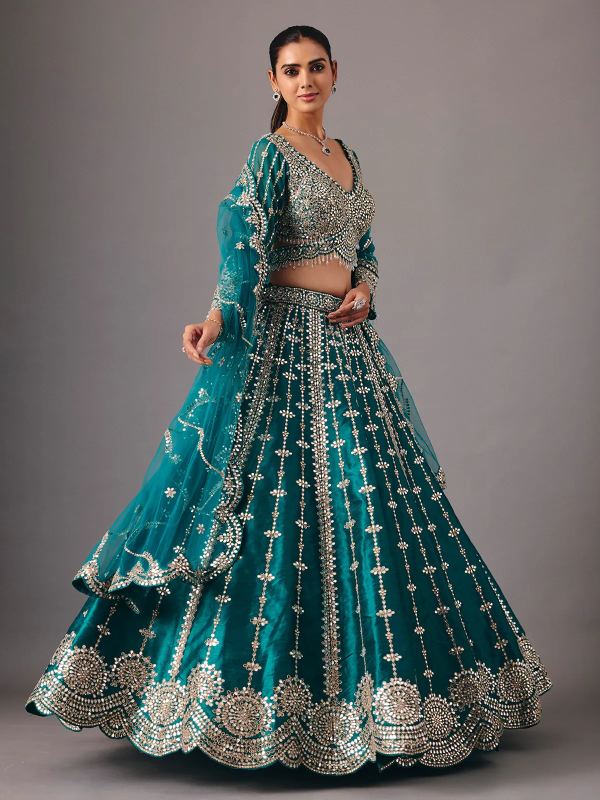 Peacock green raw silk lehenga choli with mirror accents
