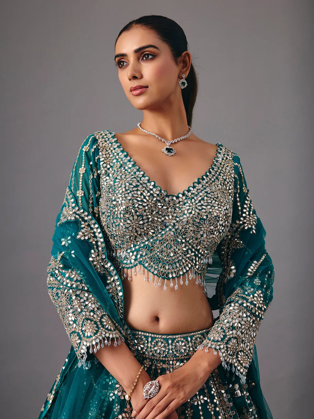 Peacock green raw silk lehenga choli with mirror accents