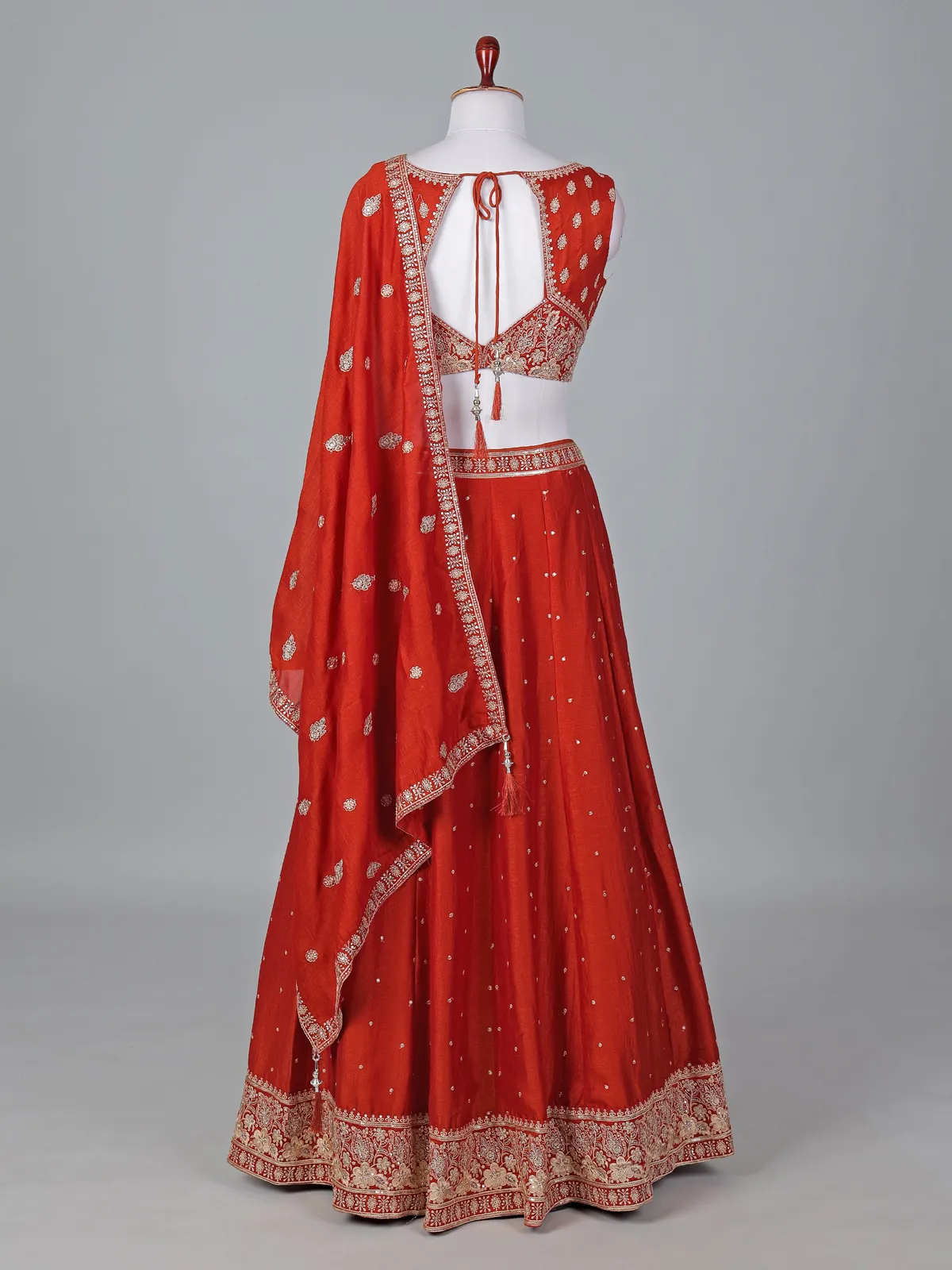 Radiant rust orange silk lehenga choli with embroidered sparkle