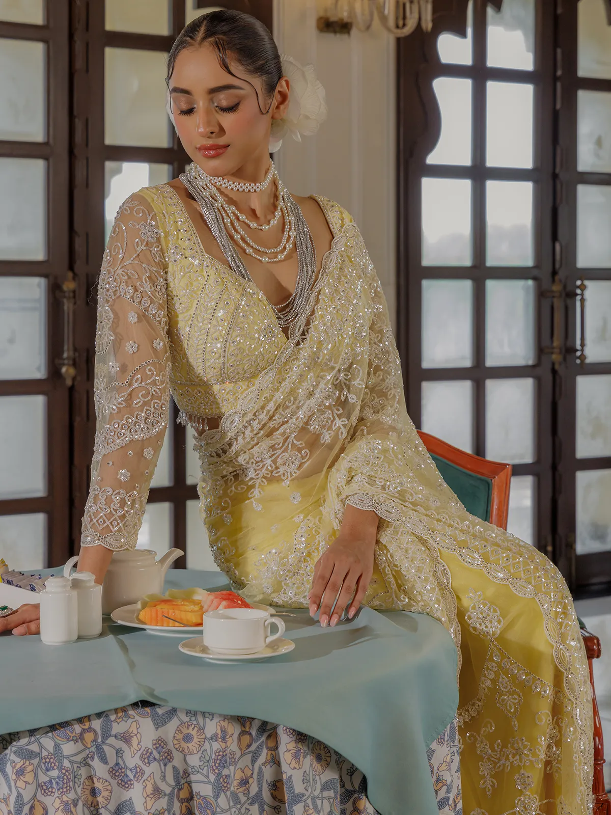 Yellow net saree for rich sequins work