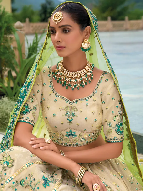 Beige and green silk wedding wear lehenga choli