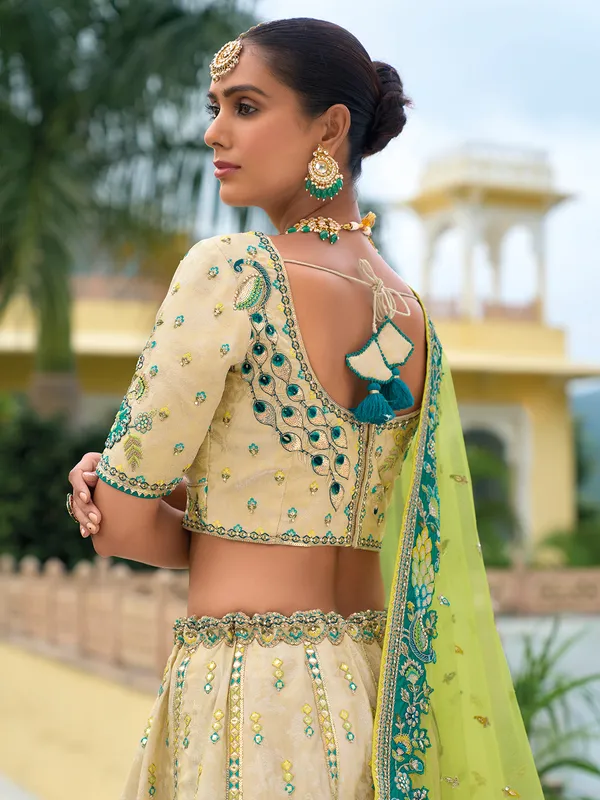 Beige and green silk wedding wear lehenga choli