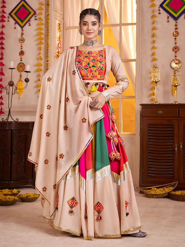 Beige navratri chaniya choli with embroidery and cowrie shell