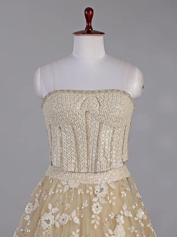 Beige net lehenga choli with sequins work