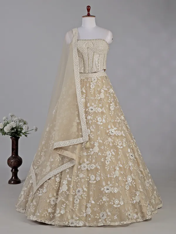 Beige net lehenga choli with sequins work