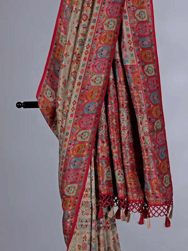 Beige pashmina silk saree with colorful motifs