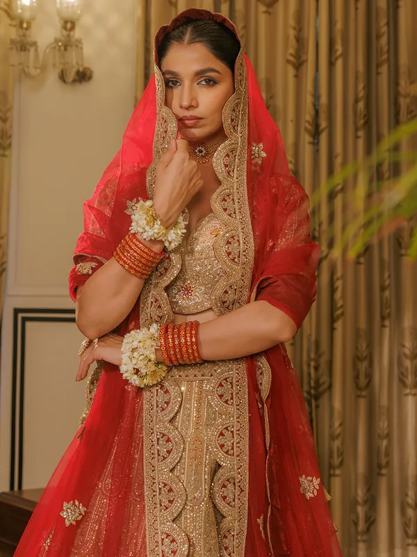 Beige silk bridal lehenga choli with red dupatta