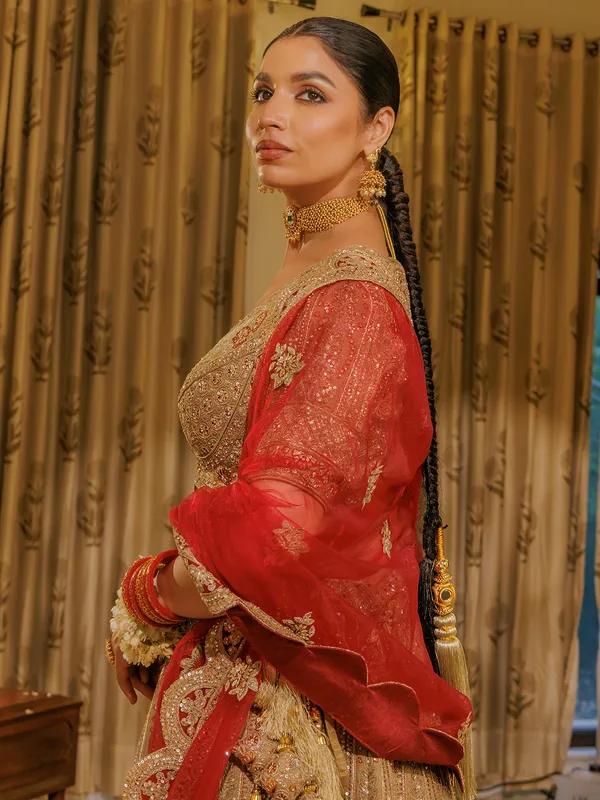 Beige silk bridal lehenga choli with red dupatta