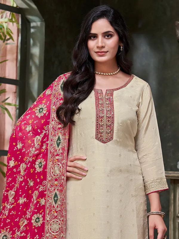 Beige silk salwar suit with printed red dupatta