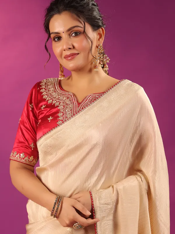 Beige silk saree with bold red blouse
