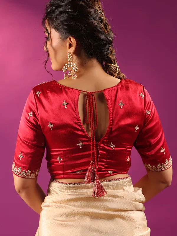 Beige silk saree with bold red blouse