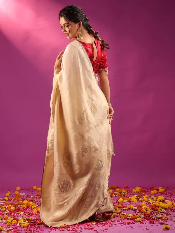 Beige silk saree with bold red blouse