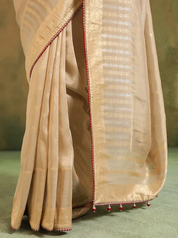 Beige silk saree with maroon contrast blouse festive wear