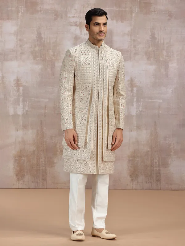 Beige silk sherwani adorned with rich resham work