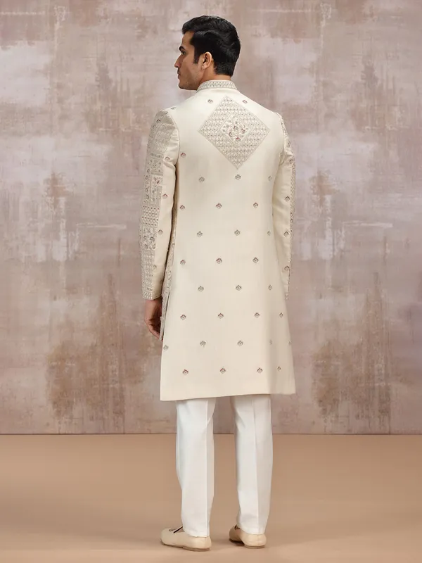 Beige silk sherwani adorned with rich resham work