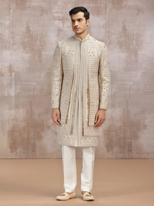 Beige silk sherwani adorned with rich resham work