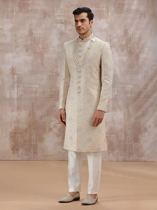 Beige silk sherwani highlighted with resham work