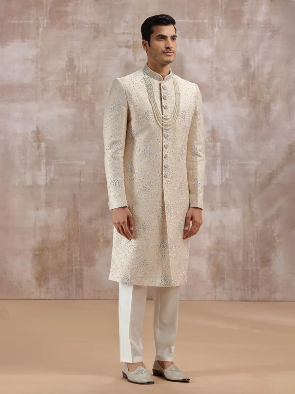 Beige silk sherwani highlighted with resham work