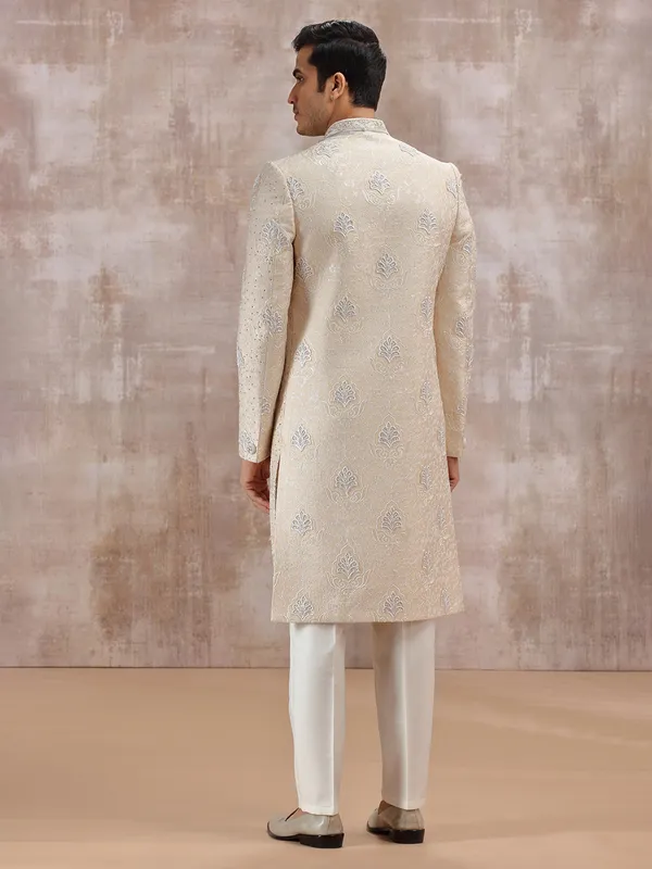 Beige silk sherwani highlighted with resham work