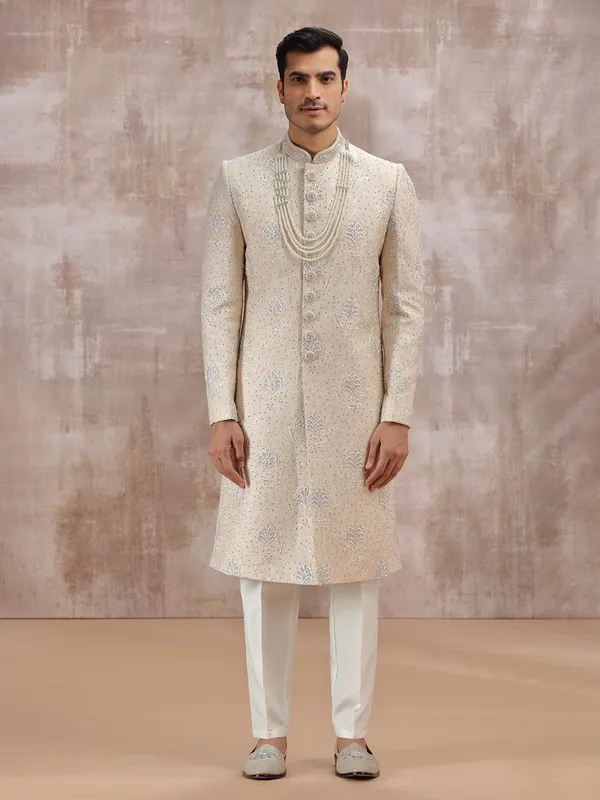 Beige silk sherwani highlighted with resham work