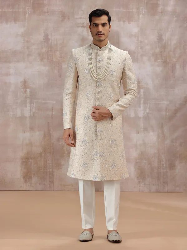 Beige silk sherwani highlighted with resham work