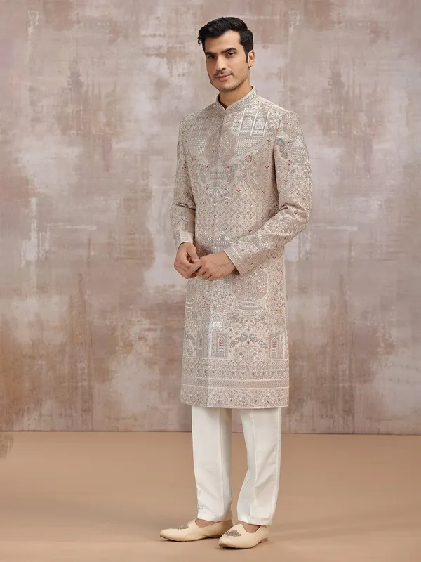 Beige silk sherwani with intricate embellishments