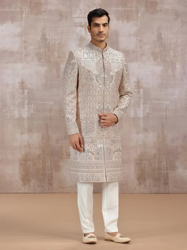 Beige silk sherwani with intricate embellishments