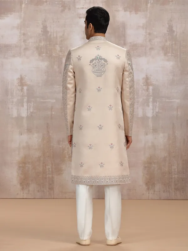 Beige silk sherwani with intricate embellishments