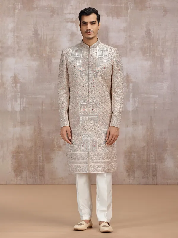 Beige silk sherwani with intricate embellishments