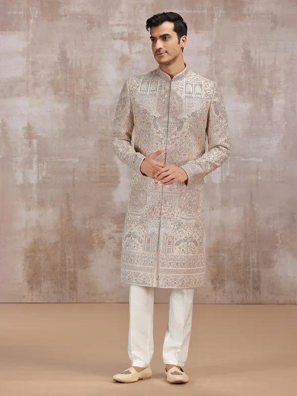 Beige silk sherwani with intricate embellishments