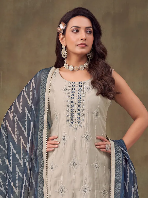 Beige silk sleeveless salwar suit with dupatta