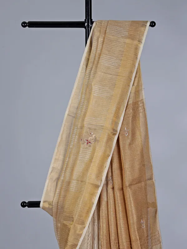 Beige tissue silk saree with cutdana work