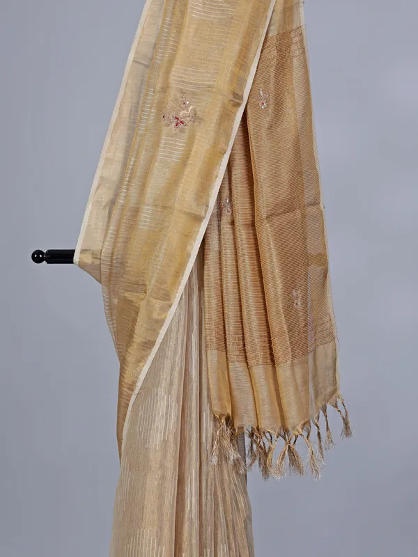 Beige tissue silk saree with cutdana work