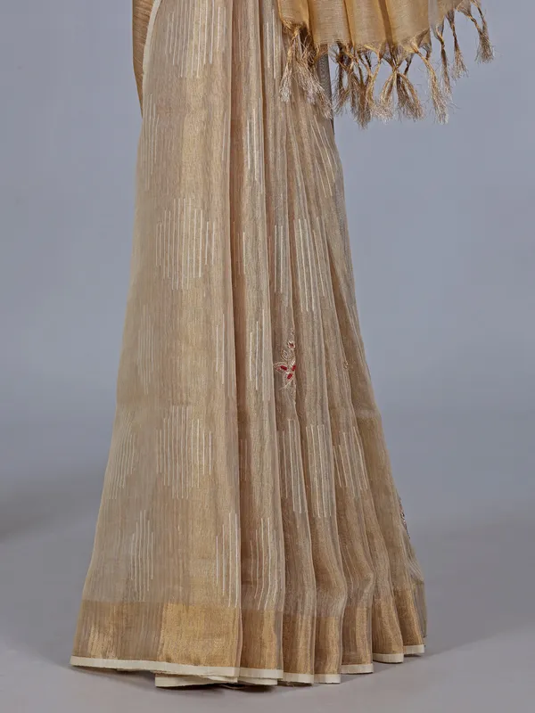 Beige tissue silk saree with cutdana work