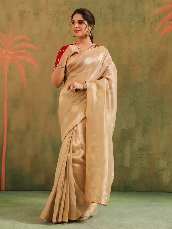 Beige zari worked silk saree with maroon blouse