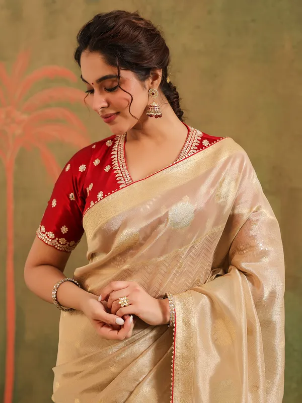 Beige zari worked silk saree with maroon blouse